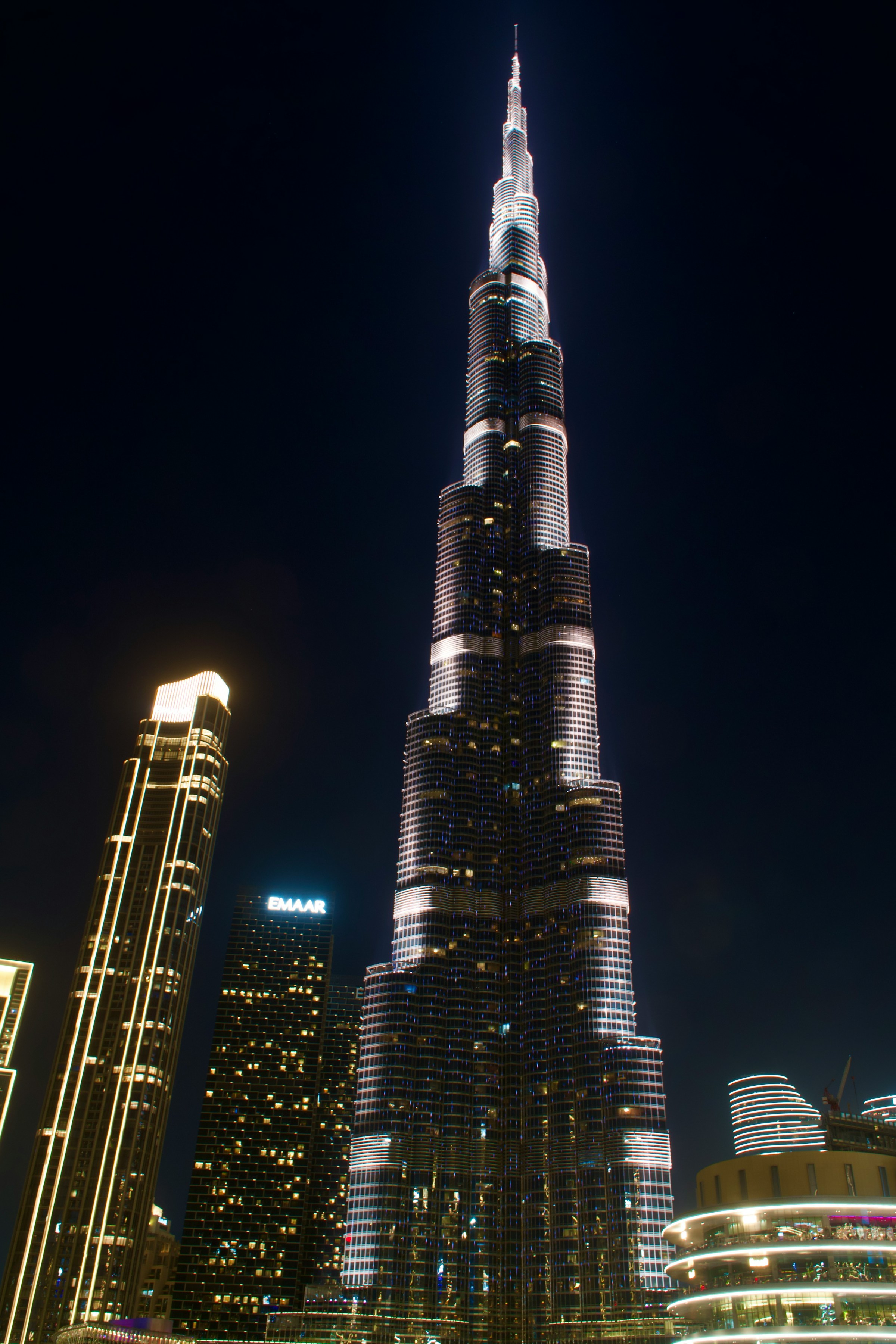 Burj Khalifa illuminated at night above Downtown Dubai — six minutes from Binghatti Wraith